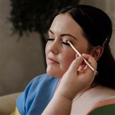 Brunette bride gets her eyeshadow applied