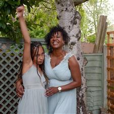 Bridesmaids pose in front of tree wearing sage dresses