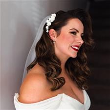 Bride with red lips and hollywood hair waves smiles