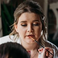 Red brick lipstick applied to bride with winged eyeliner