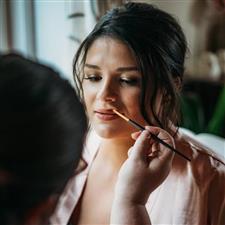 Lipgloss being applied to a brunette bridesmaid