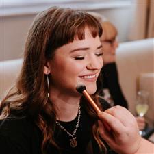 Smiling bridesmaid with eyes closed and sparkly eyeshadow