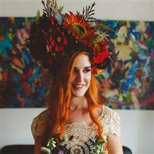 Bride with orange hair wears massive ornate flower crown