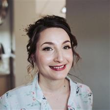 Smiling bride to be with raspberry lipstick and false eyelashes smiles into camera