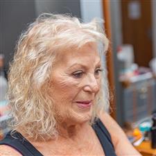 Mother of the bride checks her makeup in a mirror