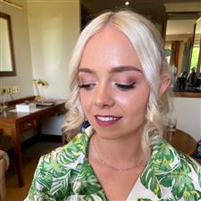 Blonde bridesmaid with pink toned makeup and dewy finish