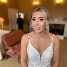 Soft pink eyeshadow on blonde bride with white strappy dress