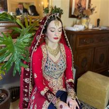 Bride in Asian dress with red lipstick and soft warm brown eyes with winged eyeliner