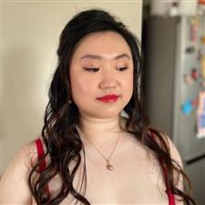 Chinese bride wearing red dress has matching red lipstick and eyeliner flicks