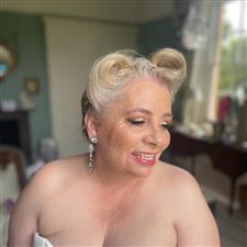 Mature bride has glamourous vintage styling with gold shimmery eyeshadow